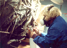 Woman working to restore sculpture